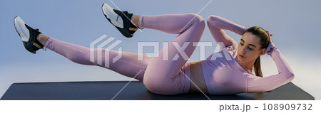 Athletic woman shaking press on studio background. Fitness, healthy lifestyle and sport concept Athletic woman shaking press on studio background. Fitness, healthy lifestyle and sport concept 108909732