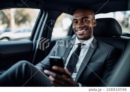 Businessman inside of a car looking at the mobile phone or using mobile phone 108910596