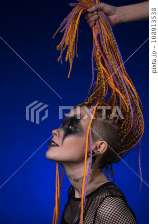 Cinematic portrait of informal woman with spooky black stage make-up and dreadlocks hairstyle 108913538