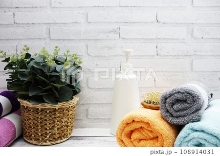 Clean bath towels with shampoo and wooden comp and interior accessories with copy space Clean bath towels with shampoo and wooden comp and interior accessories with copy space 108914031