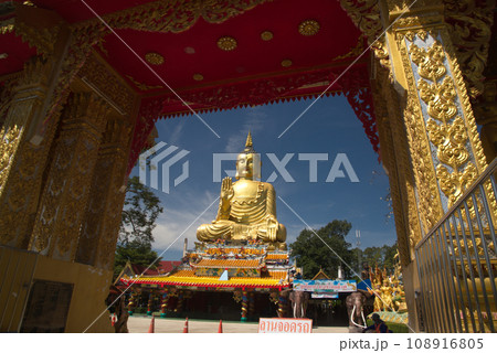 Pra Put Ratanamani Srihathai Naresuan or Luang Por Pan Lan large golden sitting outdoor Buddha in Wat Maniwong. It is a beautiful and faithful Buddha image. Located at Nakhon Nayok in Thailand. Pra Put Ratanamani Srihathai Naresuan or Luang Por Pan Lan large golden sitting outdoor Buddha in Wat Maniwong. It is a beautiful and faithful Buddha image. Located at Nakhon Nayok in Thailand. 108916805