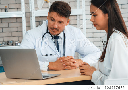 Doctor in professional uniform examining patient at hospital Jivy 108917672