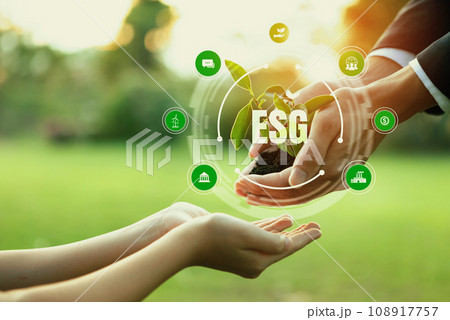 Businessman and little kid holding seedling plant together. Reliance 108917757