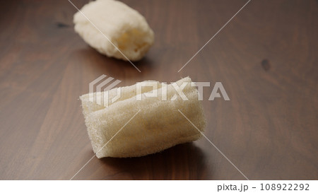Loofah sponge on walnut wood table, shot Loofah sponge on walnut wood table, shot 108922292