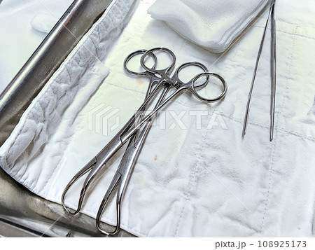 Set of surgical instruments on a hospital table 108925173