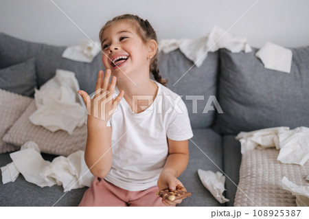 Adorable and beautiful little girl eats chocolate, but it melts in her hands, so the girl licks her fingers. Sweets. Chaos on background. Mess Adorable and beautiful little girl eats chocolate, but it melts in her hands, so the girl licks her fingers. Sweets. Chaos on background. Mess 108925387