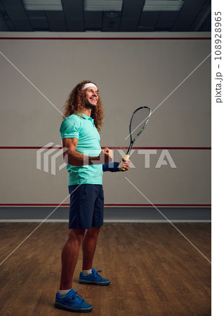 Satisfied squash player clenching fist rejoicing win in game Satisfied squash player clenching fist rejoicing win in game 108928965