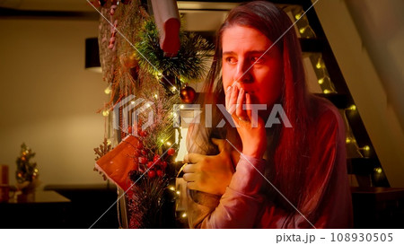 Police car lights illuminating the face of nervous and scared woman on Christmas night. Crime, problems with law and theft on winter holidays and celebrations. 108930505