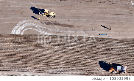 Earthmoving equipment. Aerial view of a large construction site with several earthmoving machines. Earthmoving equipment. Aerial view of a large construction site with several earthmoving machines. 108933998