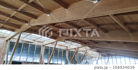 Wooden roof structure. Glued laminated timber roof. Rafters made of wood. Wooden roof structure. Glued laminated timber roof. Rafters made of wood. 108934039