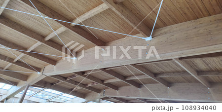 Wooden roof structure. Glued laminated timber roof. Rafters made of wood. Wooden roof structure. Glued laminated timber roof. Rafters made of wood. 108934040