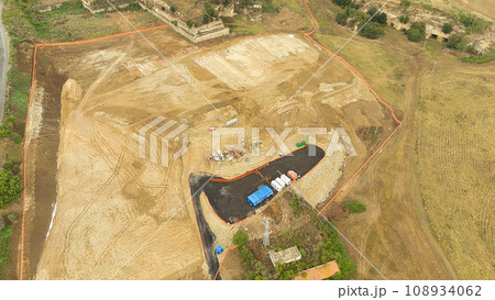 Earthmoving equipment. Aerial view of a large construction site with several earthmoving machines. Earthmoving equipment. Aerial view of a large construction site with several earthmoving machines. 108934062