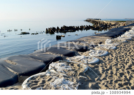 Baltiysk, Kaliningrad region, Southern pier on the Baltic spit, flood and destruction protection, shore reinforcement, embankment, concrete breakwaters 108934994