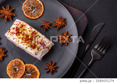 A piece of delicious sweet meringue roll with mascarpone cheese, berries and almonds 108935174