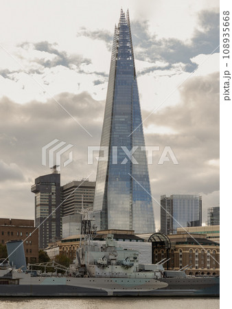 View of The Shard skyscraper, The tallest building with HMS Belfast warship museum on River Thames in front of it. View of The Shard skyscraper, The tallest building with HMS Belfast warship museum on River Thames in front of it. 108935668