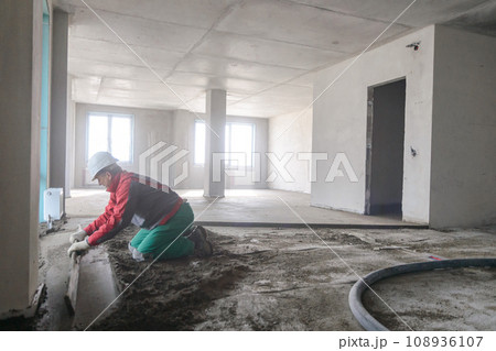 A builder in work clothes is doing his job A builder in work clothes is doing his job 108936107