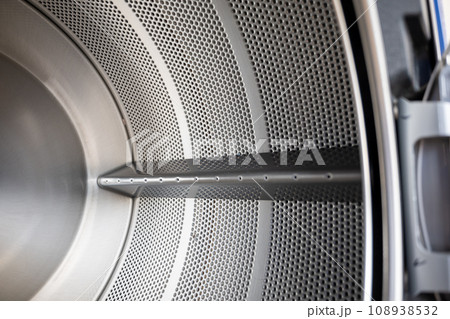 Close up Inside of washing machine tub with opened door is made of stainless steel, brand new drum material metal electrical household appliance, Empty inside Close up Inside of washing machine tub with opened door is made of stainless steel, brand new drum material metal electrical household appliance, Empty inside 108938532
