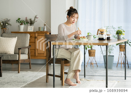 自宅で食事をとる女性 108939894
