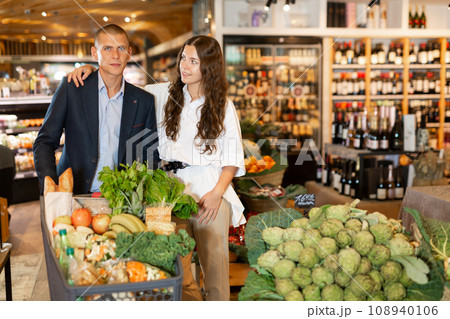 Couple shopping at vegetables department at supermarket 108940106