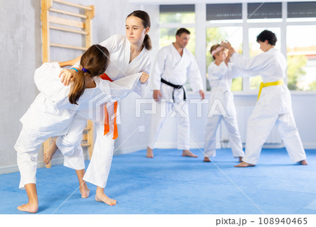 Two girls training judo techniques in studio Two girls training judo techniques in studio 108940465