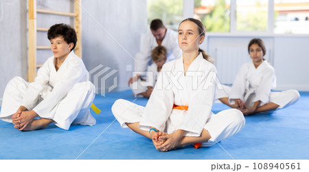 Group of children practicing butterfly pose in studio 108940561