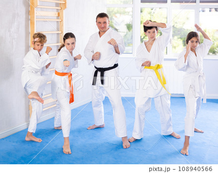 Group of children and karateka trainer posing in studio 108940566