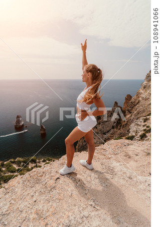 Woman travel sea. Young Happy woman posing on a beach over the sea on background of volcanic rocks, like in Iceland, sharing travel adventure journey Woman travel sea. Young Happy woman posing on a beach over the sea on background of volcanic rocks, like in Iceland, sharing travel adventure journey 108941066