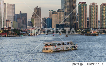 View of the buildings with a river in the foreground of the city of Bangkok 108944494