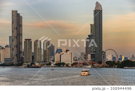 View of the buildings with a river in the foreground of the city of Bangkok 108944496