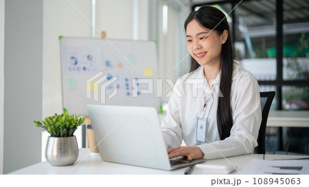 Young beautiful Asian businesswoman working for her client in her office room with laptop and office supplies. Young beautiful Asian businesswoman working for her client in her office room with laptop and office supplies. 108945063