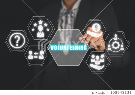 Volunteening concept, Businesswoman hand touching volunteening icon on virtual screen. Volunteening concept, Businesswoman hand touching volunteening icon on virtual screen. 108945131
