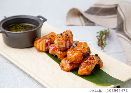 Slices of pike perch in sweet and sour sauce on a banana leaf 108945478