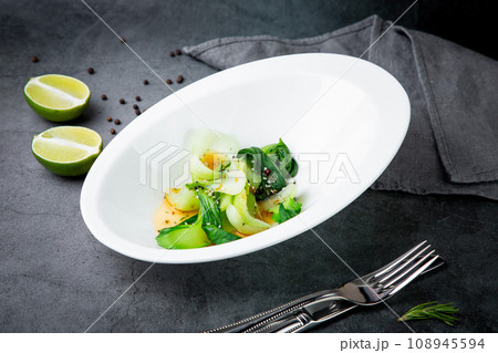 a dish of eggs and seaweed with sesame seeds and lime on the background in a beautiful plate side view 108945594