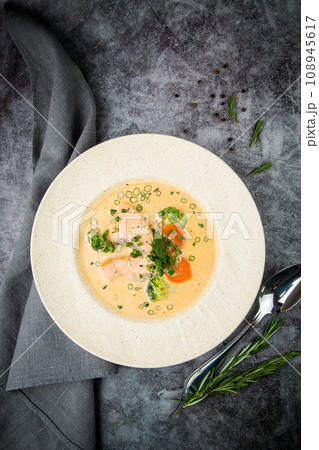 fish soup with green onions, carrots and broccoli side view fish soup with green onions, carrots and broccoli side view 108945617