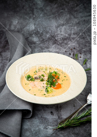 fish soup with green onions, carrots and broccoli side view 108945630