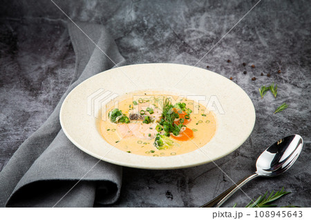 fish soup with green onions, carrots and broccoli side view fish soup with green onions, carrots and broccoli side view 108945643