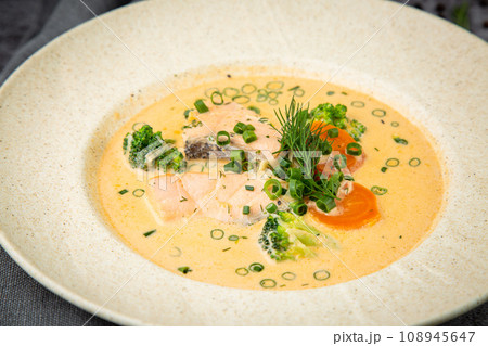 fish soup with green onions, carrots and broccoli side view 108945647