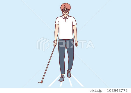 Young blind man walks through city wearing sunglasses and using cane to find way. 108948772
