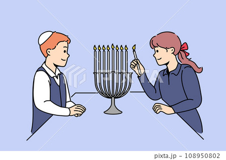 Jewish children stand near minora with burning candles, preparing for traditional holiday hanukkah 108950802