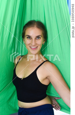 Portrait of young russian woman 31 year old looking side against green background 108950948