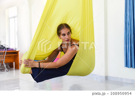 Young woman making aerial or fly yoga pose Young woman making aerial or fly yoga pose 108950954