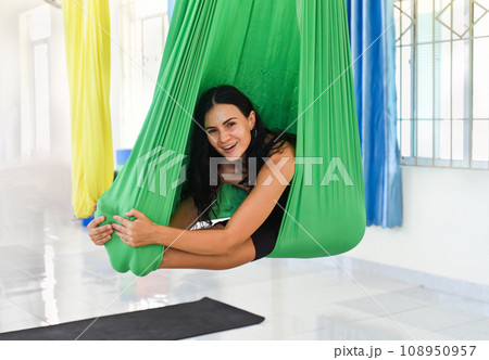 Young woman making aerial or fly yoga pose Young woman making aerial or fly yoga pose 108950957