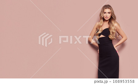 Young blonde woman in black evening dress Young blonde woman in black evening dress 108953558