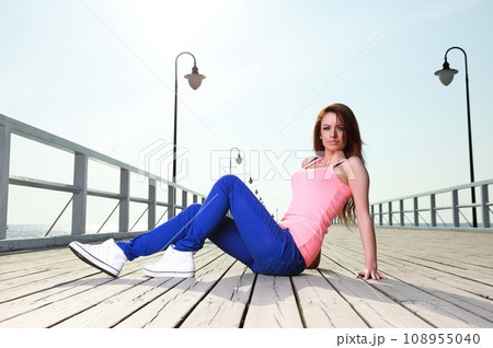Attractive girl young woman on sea pier  108955040