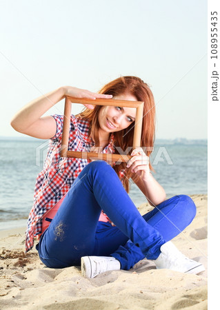 Woman holding frame, travel concept. 108955435