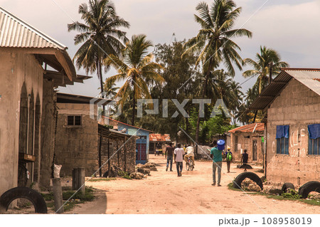 African road through village people going about business 108958019