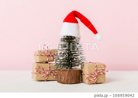 Christmas composition. Gifts, small tree, branches and craft DIY decorations on white background. New year concept. Christmas home decoration Flat lay, top view, copy space 108959042