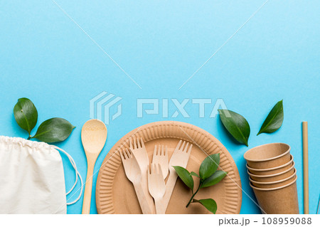 set of empty reusable disposable eco-friendly plates, cups, utensils on light white colored table background. top view. Biodegradable craft dishes. Recycling concept. Close-up set of empty reusable disposable eco-friendly plates, cups, utensils on light white colored table background. top view. Biodegradable craft dishes. Recycling concept. Close-up 108959088