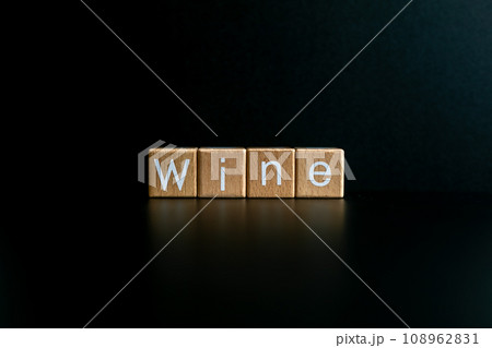 Wooden blocks form the text "Wine" against a black background. 108962831