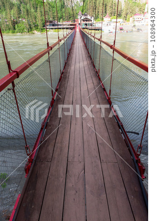 Famous bridge over Katun river in valley of Altai Mountains. 108964300